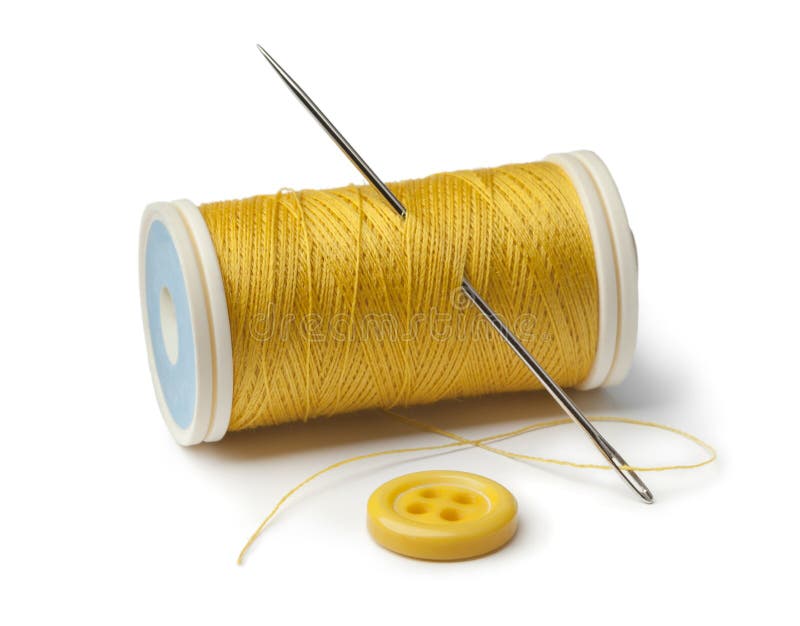 Yellow bobbin, needle and sewing button