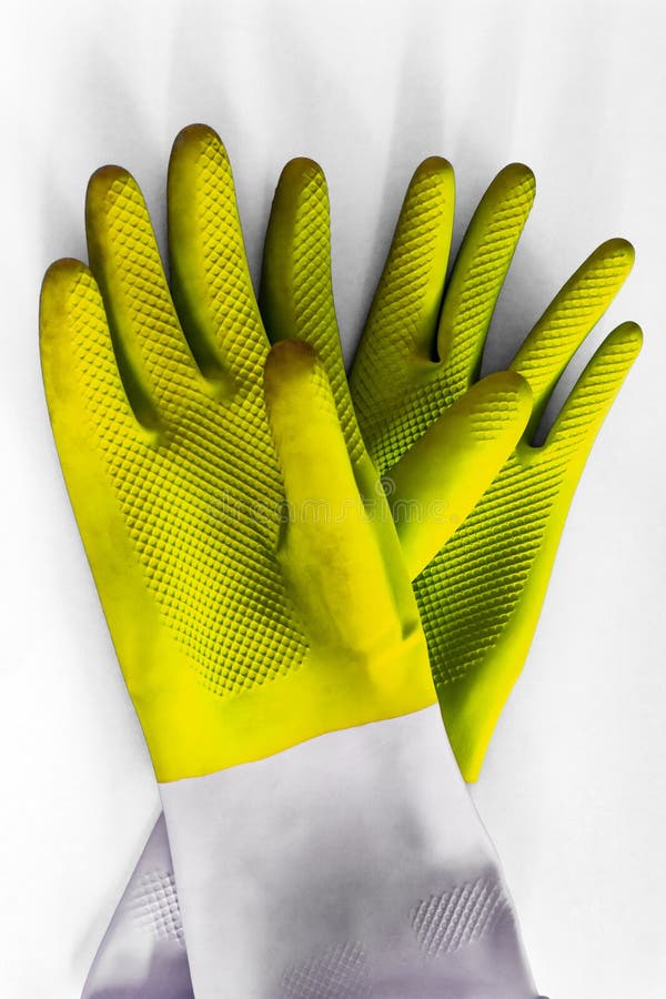 Yellow bright durable rubber gloves for cleaning isolated on white background. Closeup top view. General or regular cleanup. stock images Yellow bright durable rubber gloves for cleaning isolated on white background. Closeup top view. General or regular cleanup. stock images