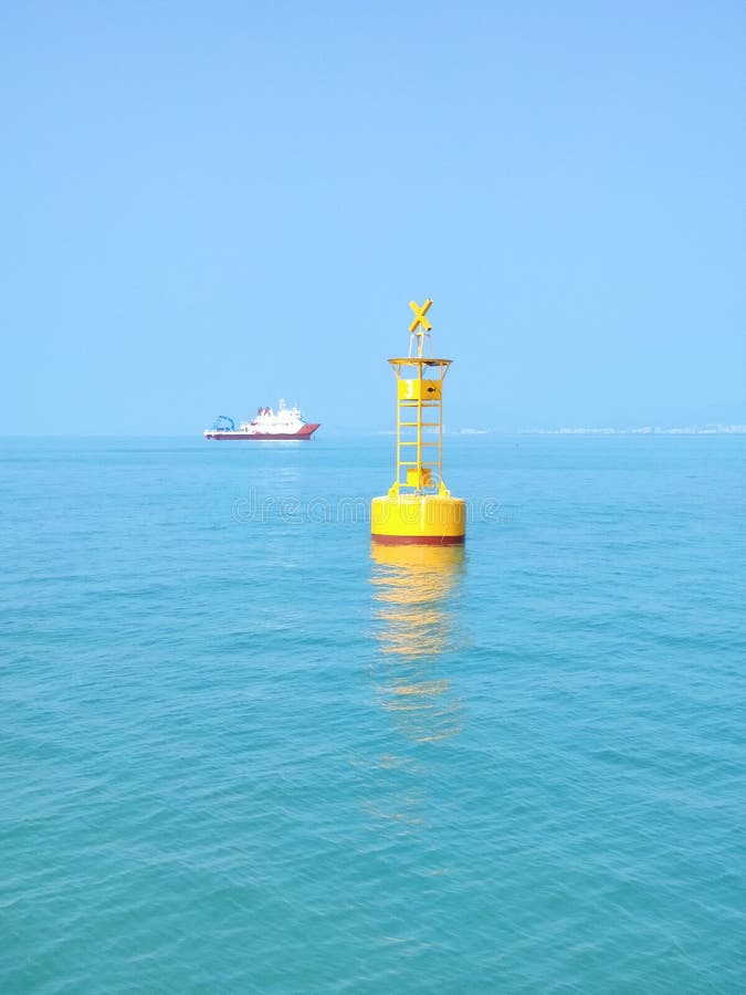 A yellow buoy in the deep blue sea