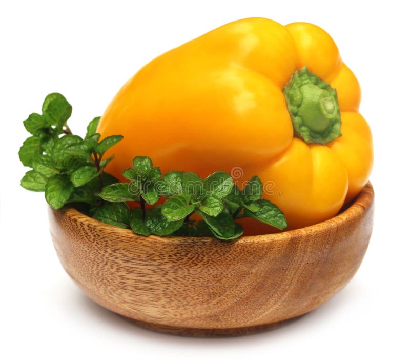 Yellow capsicum with mint leaves stock image