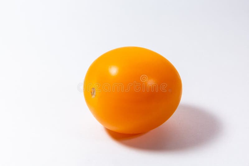 Yellow cherry tomato lies on a white background royalty free stock photos Yellow cherry tomato lies on a white background royalty free stock photos