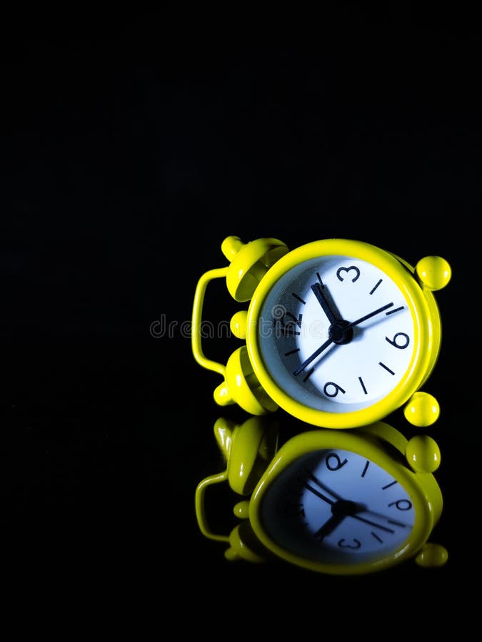 A Yellow Clock with Reflection on a Black Background. Stock Image Image of gadget, watch