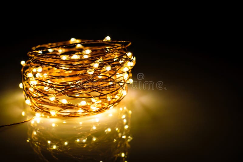 Yellow Colored Light Chain for Decoration Placed on a Reflective