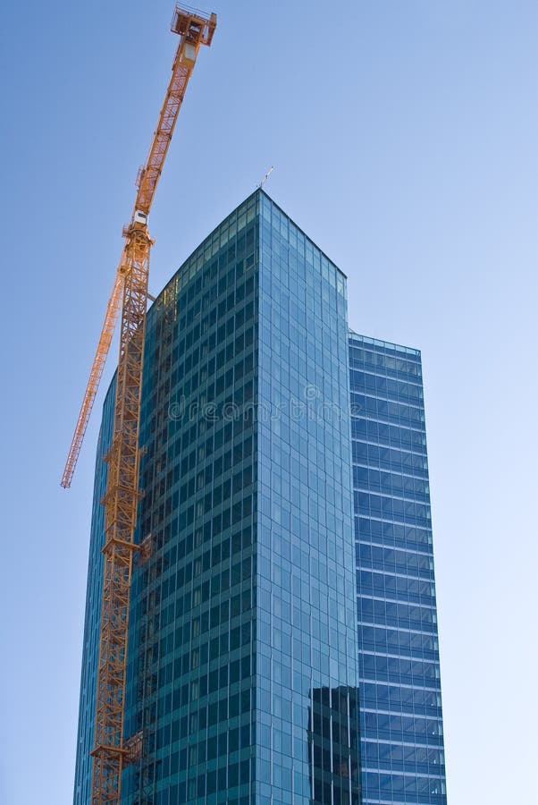 Yellow crane and skyscraper