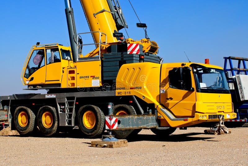 Yellow Crane Truck Parked On Brown Field Picture. Image 114603395