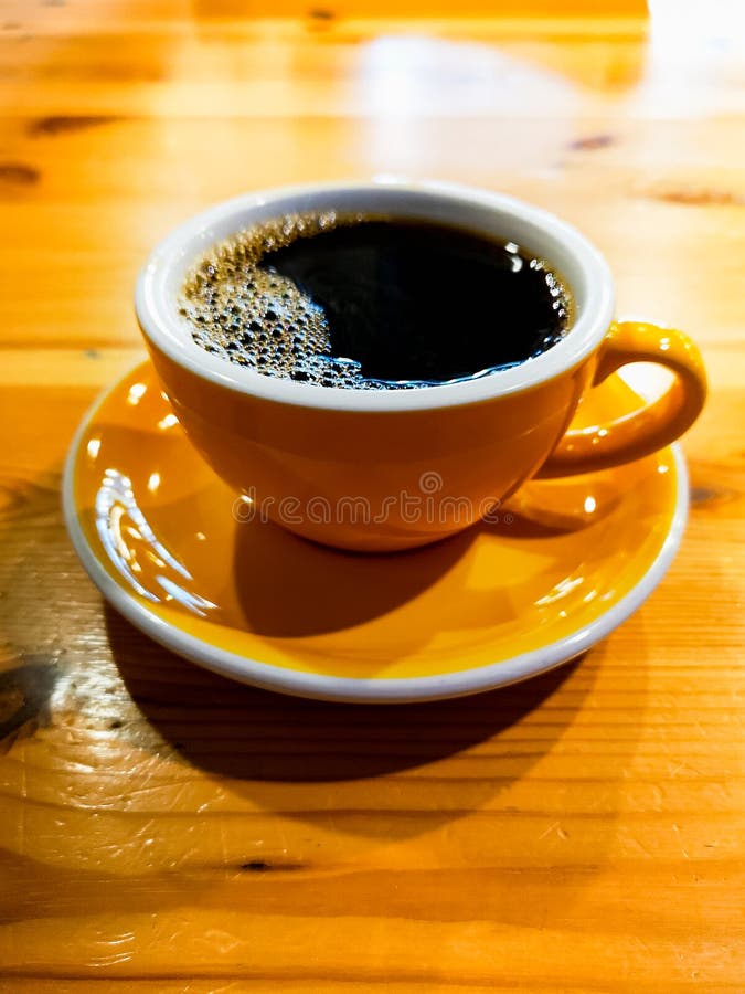 Yellow Cup of Black Overflow Coffee in Small Cafe Stock Image Image