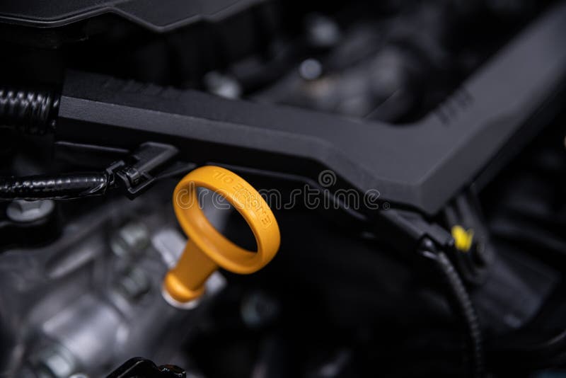 Yellow oil dipstick in car engine. Measuring level of engine oil. Dipstick  oil level gauge with yellow color for Checking engine oil level of engine s  Stock Photo - Alamy