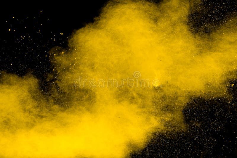 Yellow Dust Particles Explosion on Black Background.Yellow Powder