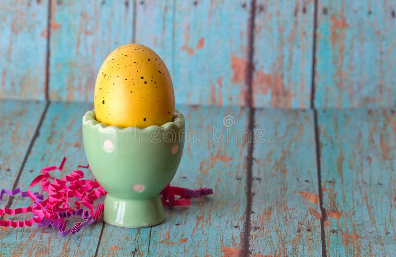 Yellow Easter Egg in a Pastel Green Egg Holder Stock Image Image of