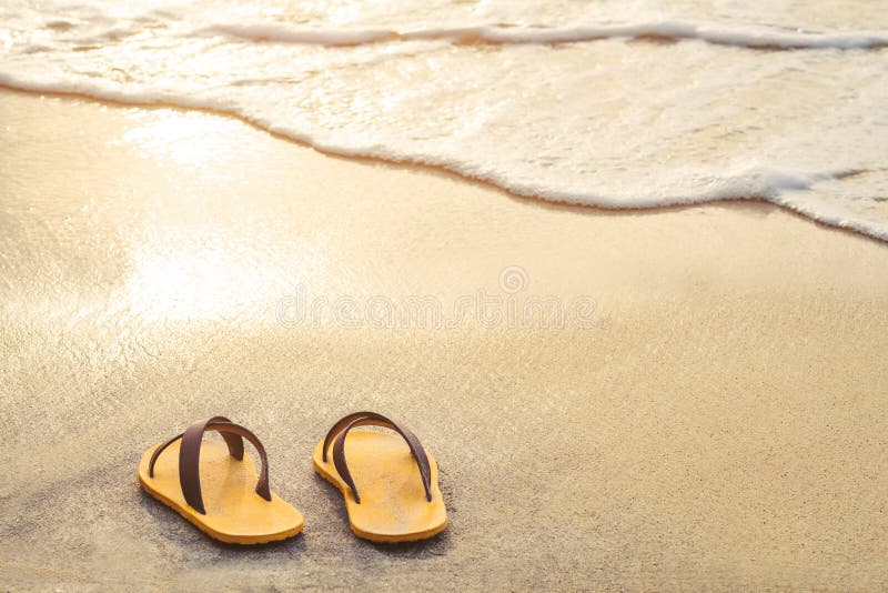 Yellow Flip Flop on the Beach with Bright Light of Sunset in Summer ...