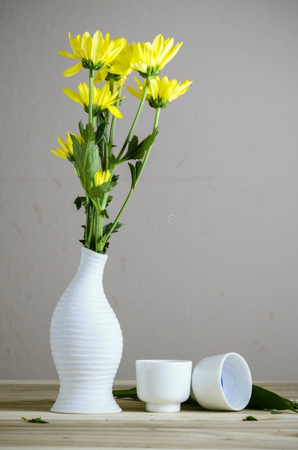 Yellow flower on vase still life photograph