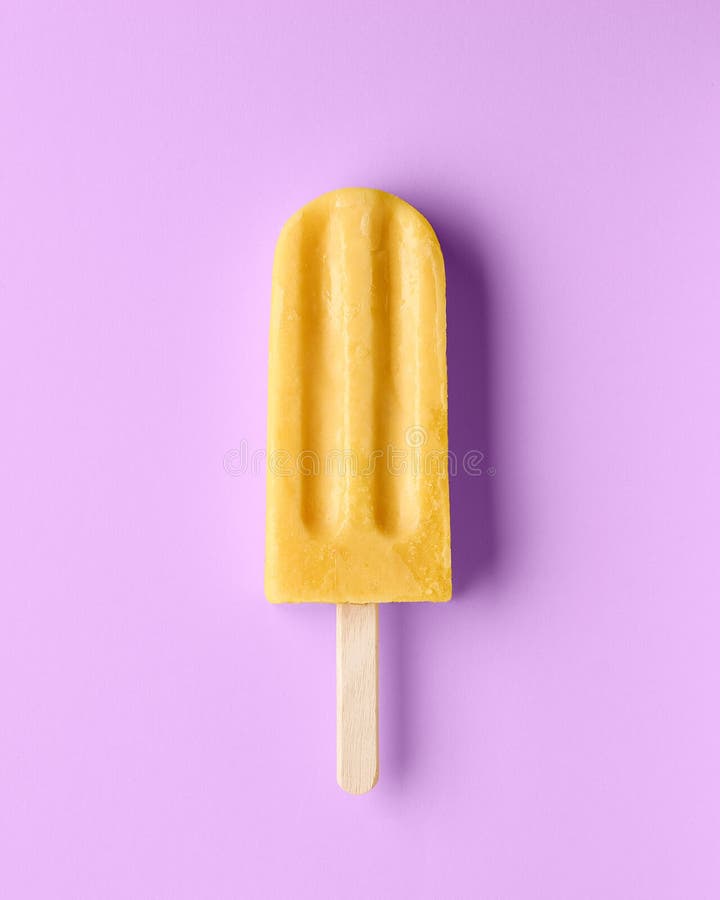 Yellow fruit popsicle on light purple background, top view. Mango, banana, passion fruit and pineapple flavor