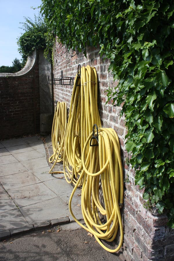 Garden Hose Hanging On The Wall Stock Image Image of grey, hanged