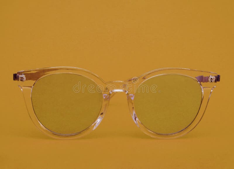 Yellow Glasses with a Transparent Frame on a Yellow Background. Stock