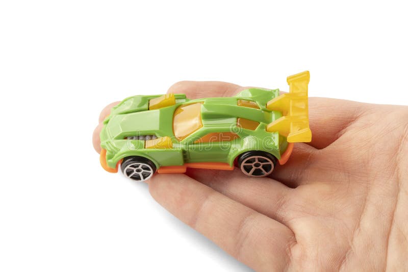 Yellow and green car toy in hand stock image Yellow and green car toy in hand stock image