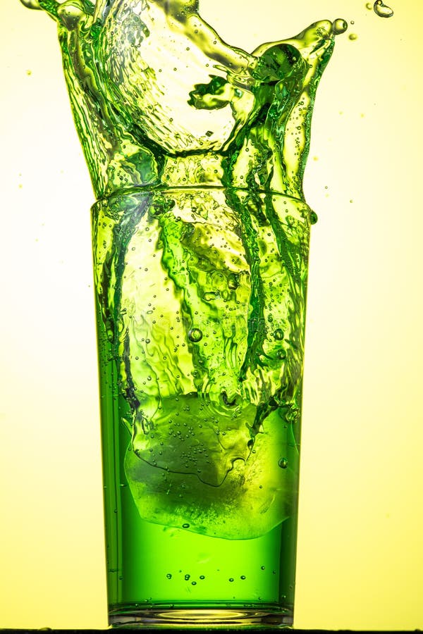 Yellow or Green Carbonated Lemonade in a Glass with Ice, Flow and Splash Stock Photo Image of