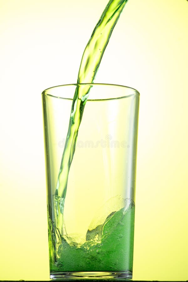 Yellow or Green Carbonated Lemonade in a Glass with Ice, Flow and Splash Stock Photo Image of