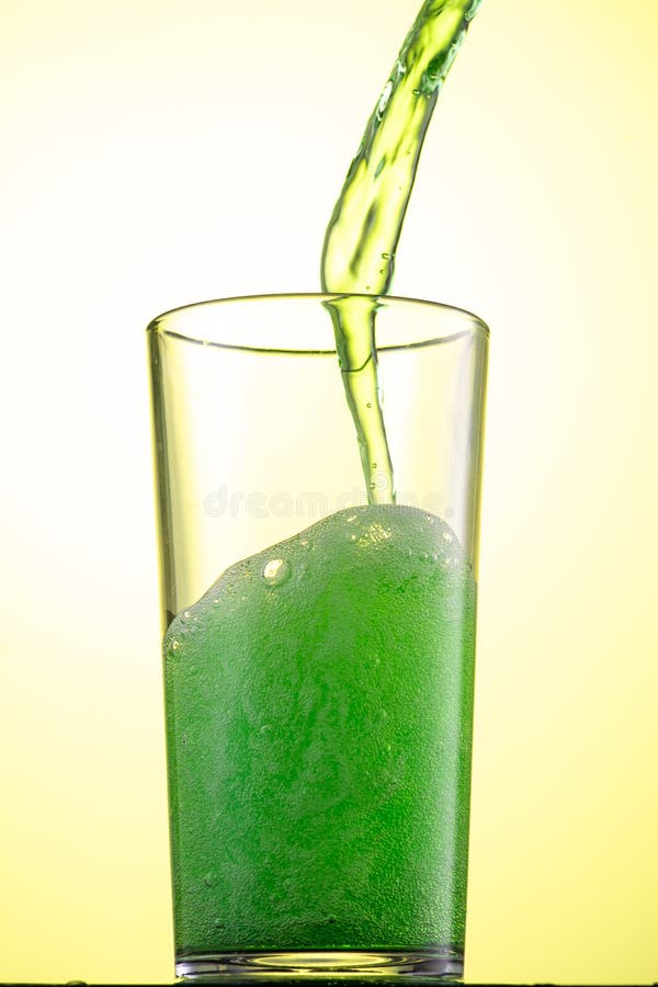 Yellow or Green Carbonated Lemonade in a Glass with Ice, Flow and Splash Stock Photo Image of
