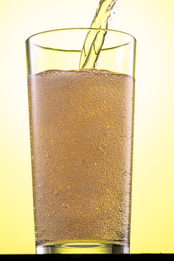 Yellow or Green Carbonated Lemonade in a Glass with Ice, Flow and Splash Stock Photo Image of