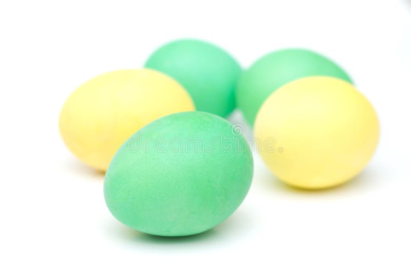 Yellow and green Easter eggs isolated on white