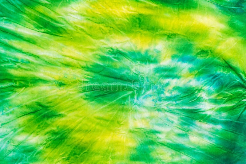 Yellow-green fabric in tie dye style. Flat lay.