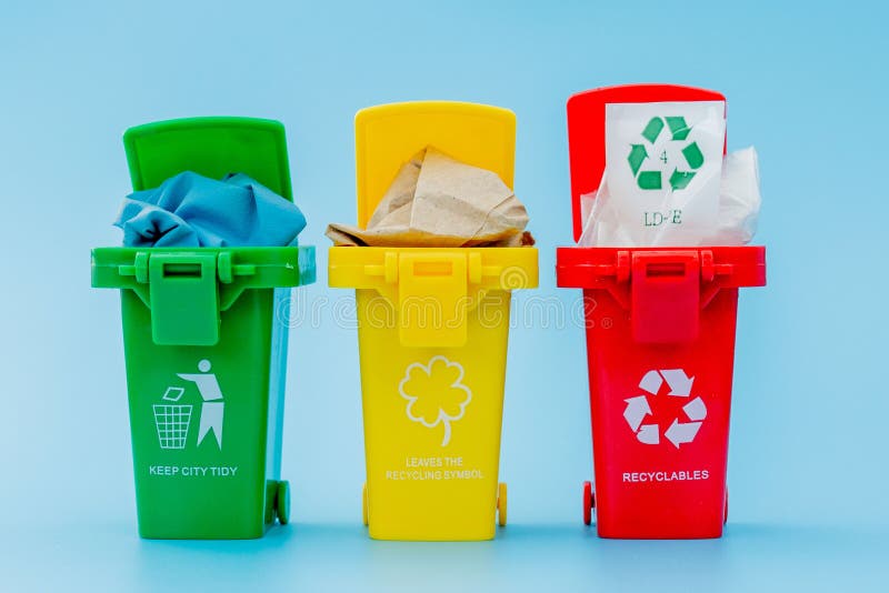 Yellow, Green and Red Recycle Bins with Recycle Symbol on Blue ...