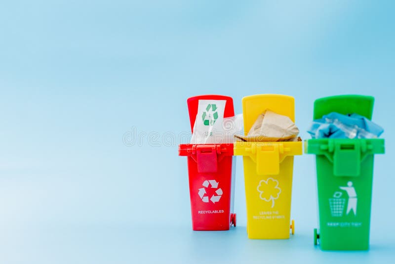 Yellow, Green and Red Recycle Bins with Recycle Symbol on Blue ...