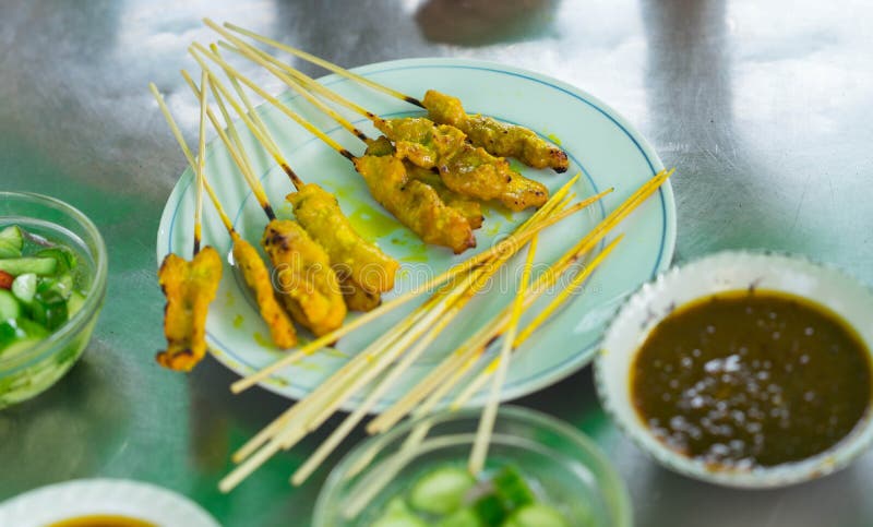 Yellow grilled pork in stick called pork satay in plate with di royalty free stock photo Yellow grilled pork in stick called pork satay in plate with di royalty free stock photo