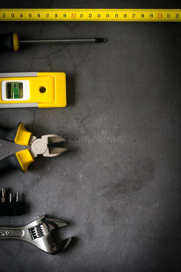 Yellow Hardware Tools on Black Concrete Background with Some Space for Text  Stock Photo - Image of centimeter, concept: 161587214