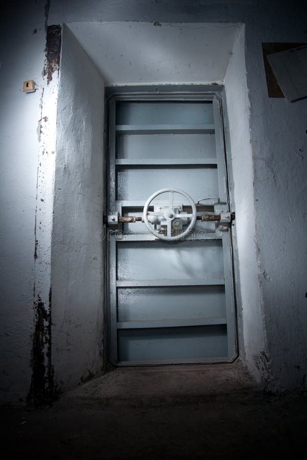 Yellow hermetic metal armored door with valve, entrance of soviet bomb shelter