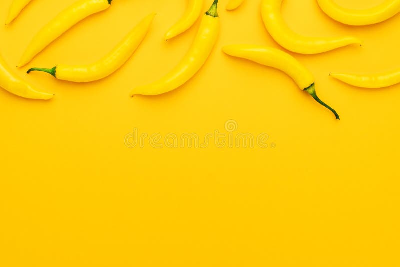 Yellow Hot Chilli Peppers With Copy Space. Yellow Background With Many