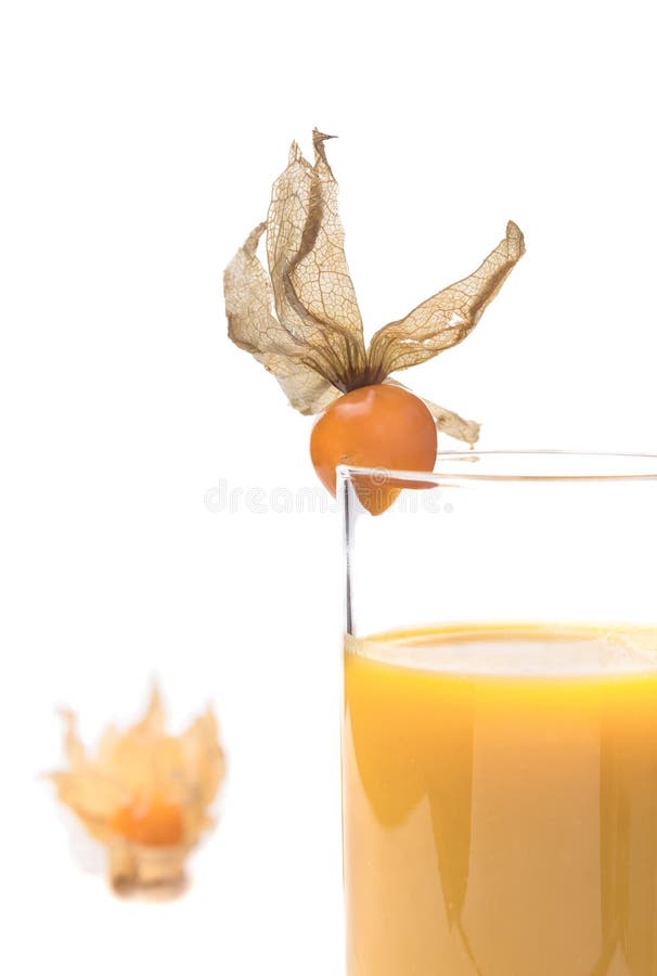 Yellow juice in glass decorated with Physalis,isolated