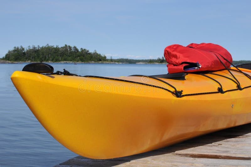 Yellow kayak stock image. Image of jacket, wood, boat 5731167