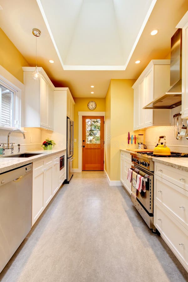 Yellow Kitchen With White Cabinets And Stove Stock Photo Image