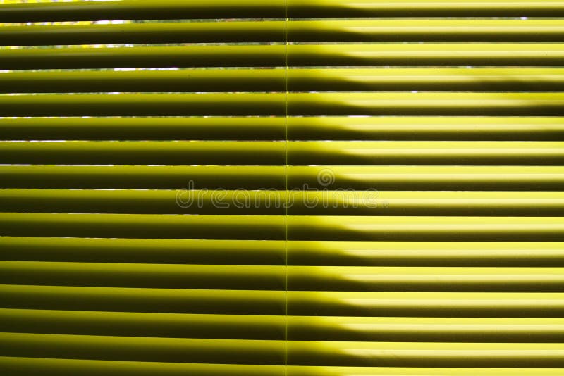 Yellow lamellas of vertical blind shining in natural sun light royalty free stock photos Yellow lamellas of vertical blind shining in natural sun light royalty free stock photos