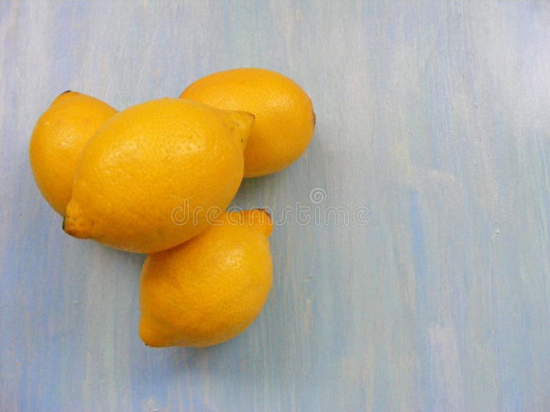 Yellow lemons on a blue wooden shabby background stock photos Yellow lemons on a blue wooden shabby background stock photos