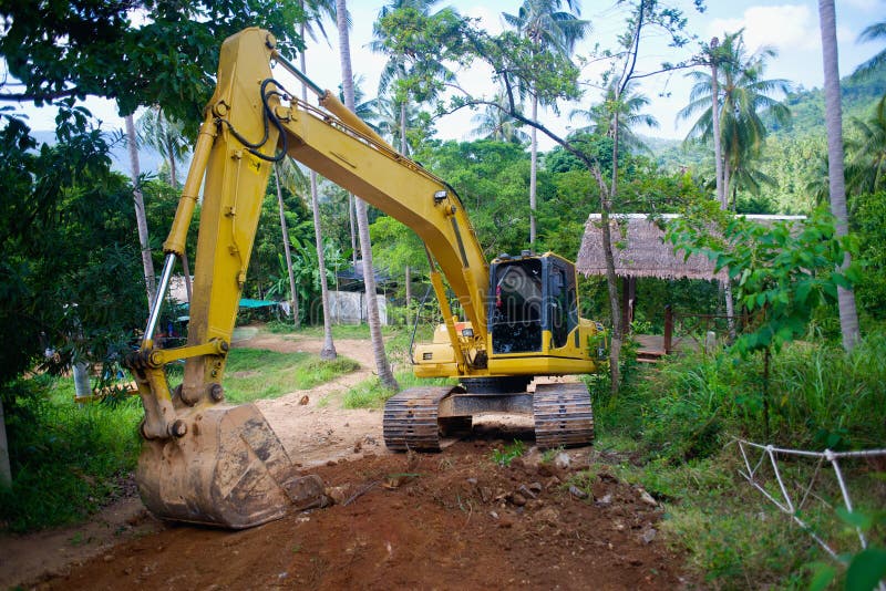 Yellow loader mashine digging the road