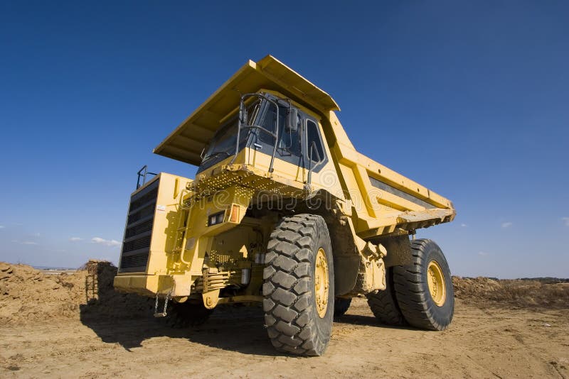A picture of a big yellow mining truck at worksite