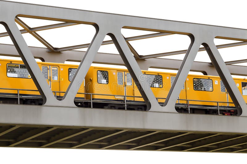 Yellow moving train on an iron bridge with blue sky, isolated on