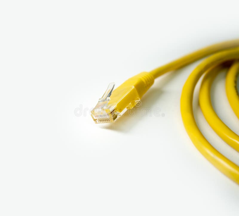yellow network cable on white background. cat 5 wire with rj45 tip. copy space