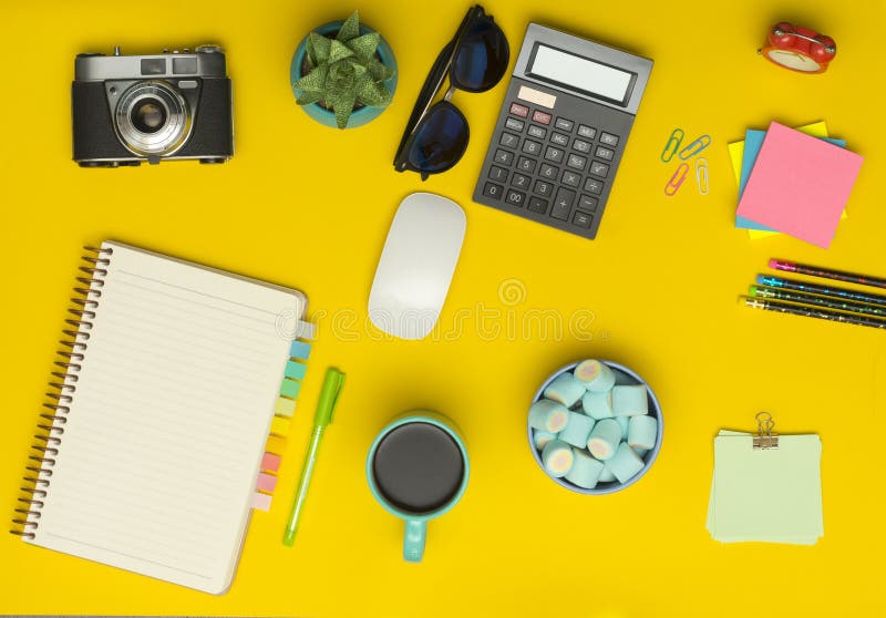 Yellow Office Desk Table with Camera, Notebook, Calculator, Cup of