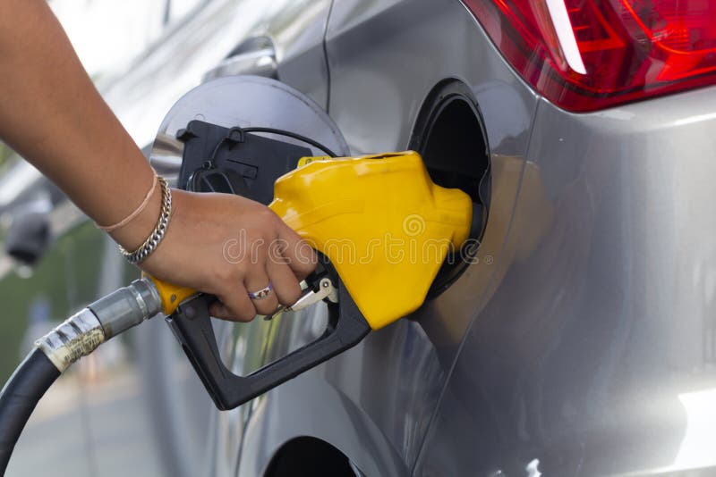 Oil petrol pump filling nozzles in gas station service. Yellow oil petrol pump filling nozzles in gas station service. Concept of fuels, gasoline, diesel stock photo Oil petrol pump filling nozzles in gas station service. Yellow oil petrol pump filling nozzles in gas station service. Concept of fuels, gasoline, diesel stock photo