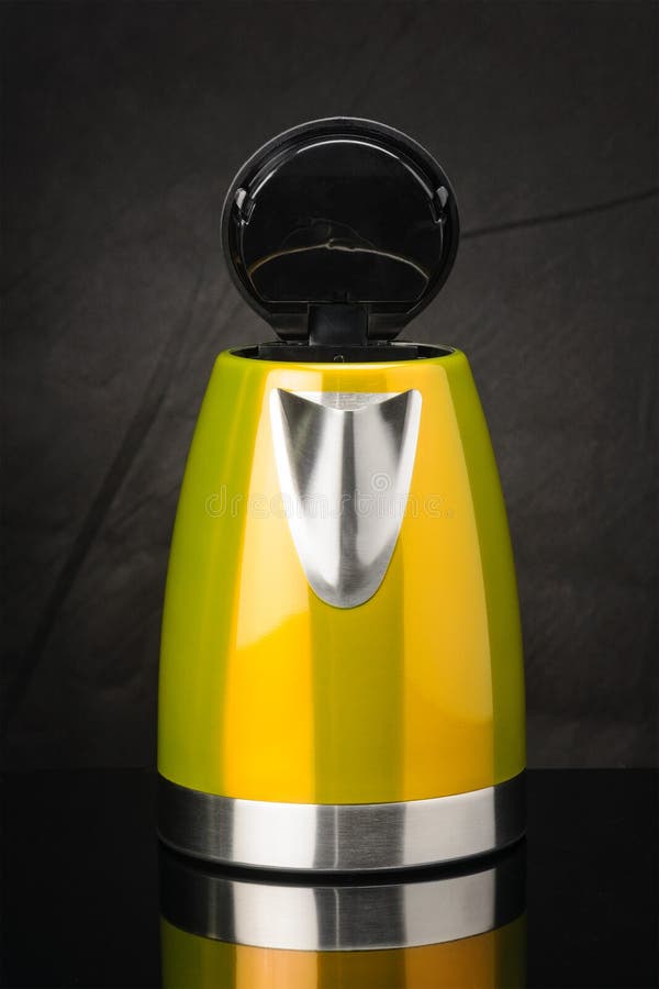 Yellow stainless steel kettle on black mirror background with open lid. Yellow painted stainless steel electrical kettle on black mirror background with open lid stock photo Yellow stainless steel kettle on black mirror background with open lid. Yellow painted stainless steel electrical kettle on black mirror background with open lid stock photo