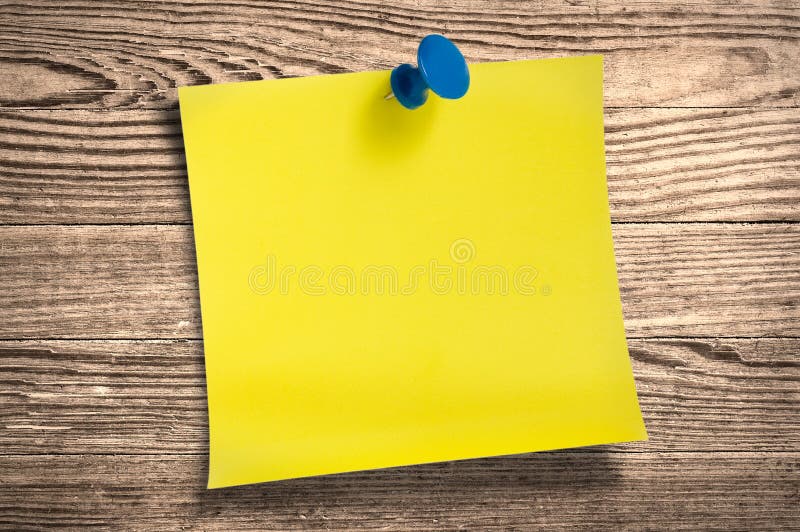 Yellow paper note on wood, clipping path.