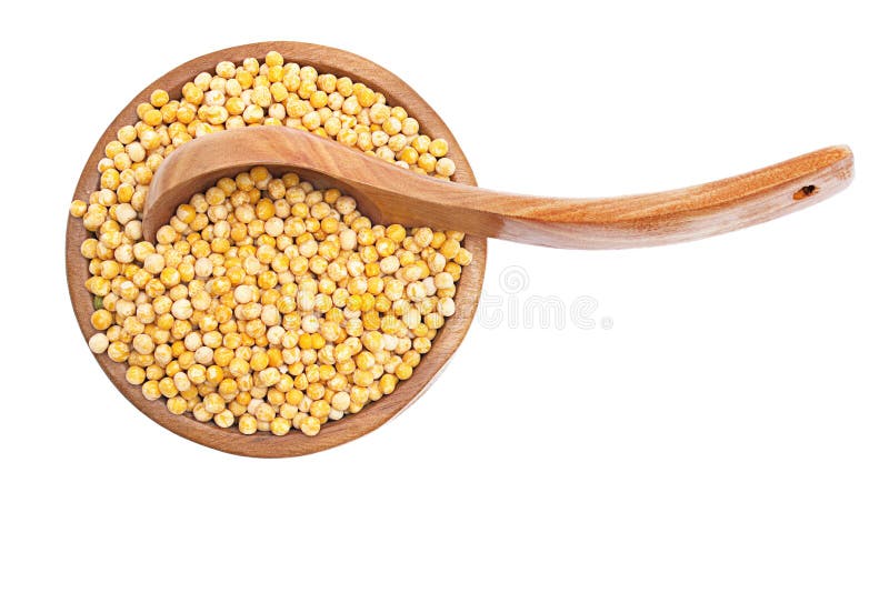 Yellow peas in the bowl with wood spoon