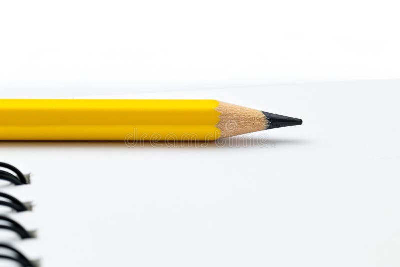 Yellow pencil on open spiral notebook with blank pages. Education, business, accounting, planning background. AI generated