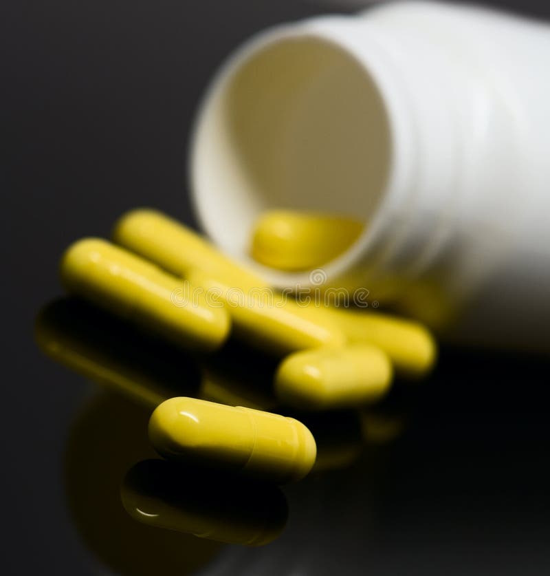 Yellow pills and a bottle stock image. Image of illness 37788293