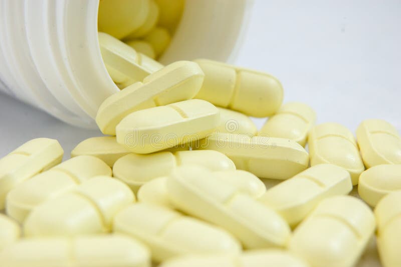 Yellow pills spilled out from bottle