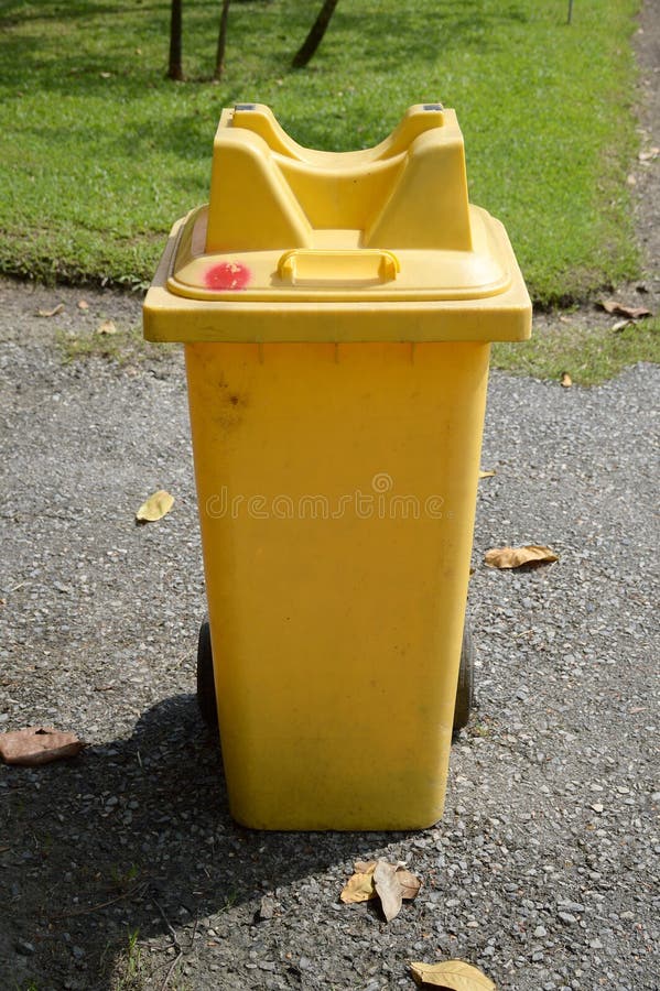 Yellow plastic bin stock image. Image of waste, road 78902829