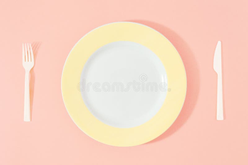 Yellow plate knife fork pink background Top view flat lay Diet m stock photo Yellow plate knife fork pink background Top view flat lay Diet m stock photo